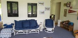 white wicker love seat, chair with blue cushions, shadow boxes