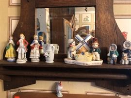 Mirrored wall shelf and porcelain figurines.