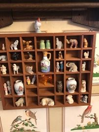 Printer's tray style display with many miniature figures.