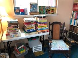 Board games and cane-back rocking chair.