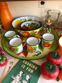 Brightly stenciled enamelware trays, bowls & mugs.