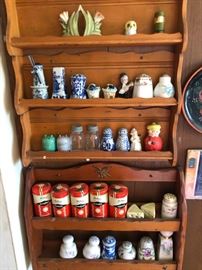 Wooden spice racks with salt & pepper collectibles.