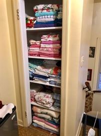 Linen closet filled with retro colors and patterns.