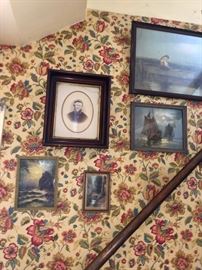 Framed wall art and antique photographs.