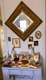 Bedroom wicker vanity and Victorian-era gesso square mirror.