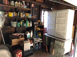 Typical garage stuff and a white wood storage cabinet.