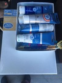 Set of acrylic paint, paint brushes, and two blank canvases