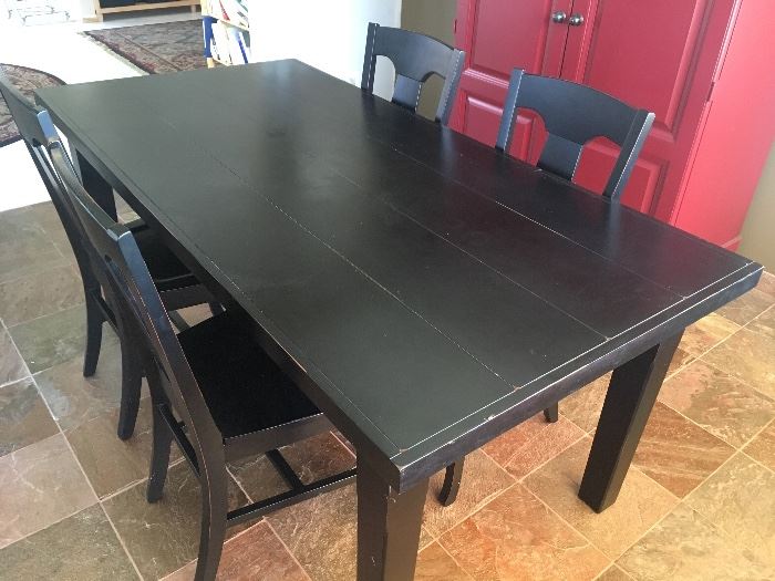 Pottery Barn black dining table- includes 2 leaves, 2 additoinal upholstered chairs, and 3 seasons of chair covers