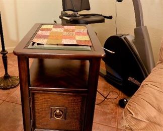 SIDE TABLE AND STATIONARY EXERCISE BIKE.