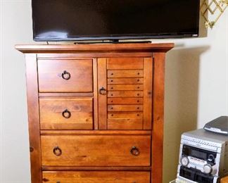 TV AND DRESSER FOR MORE STORAGE.