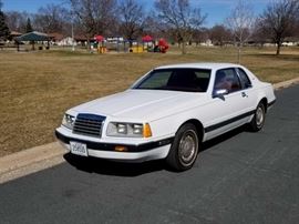 1985 30th Anniversary Year Ford Thunderbird Elan Coupe with 5.0L, fuel-injected V8 engine, original white paint with red pin stripe and red interior.
This 1985 Thunderbird has been owned by one family, and was purchased new in 1985 in Antioch, CA. For the next 18 years, it was only driven 66,264 miles, until the owner's death. It was then passed down to his daughter, in 2003, who only put an additional 17,474 miles on the vehicle. It has never been smoked in, never driven in snow or on salted roads, and has always been garaged. Copy of the Carfax report and recorded maintenance items available.  
This Elan edition has a loaded interior, keyless entry buttons, power steering, power brakes, power door locks and windows, power mirrors, power seat adjustments, digital displays and console, electronic climate control, and low mileage on one of Ford's best engines! 

Year: 1985
Make: Ford
Model: Thunderbird
Vehicle Type: Passenger Car
Mileage: 83,706
Plate: MN Collector 358535
Body Type: 2 D