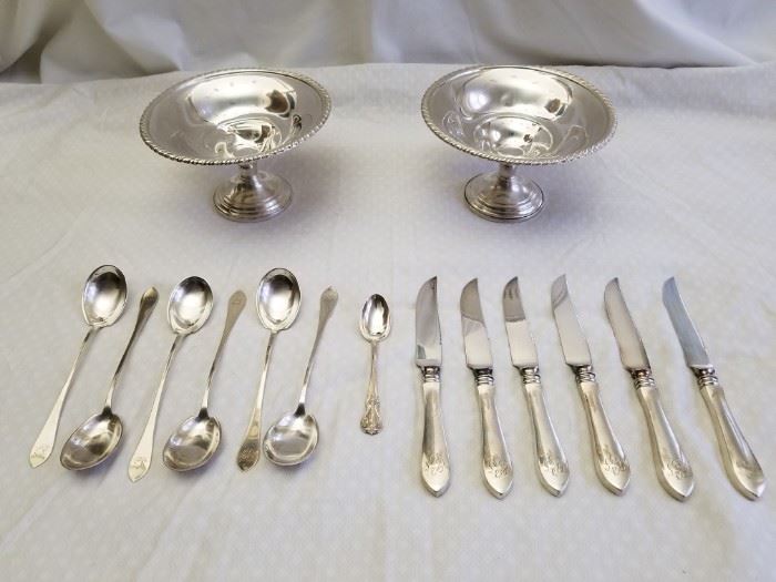 Polished, Sterling Silver flatware and dishes. All items are sterling silver and Includes: 6 matching spoons with 6 matching pattern knives, 1 small spoon, and 2 reinforced sterling pedestal bowls/sweet dishes. All items marked "sterling". Spoon set and knives are marked "sterling" and spoons have makers mark on back, but we couldn't determine the maker (see pics). Small spoon is Towle Sterling. The two bowls have makers marks and are marked "Sterling Re-Enforced 1111". One bowl has a couple "dents" on the inside (see pics). All items marked "Sterling". See pictures for complete details and makers marks.