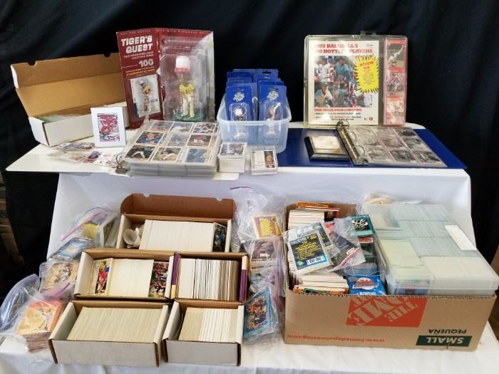 Large collection of Baseball and Basketball cards, collectible items and more! Topp's, Donruss, and Bowman's Best brands included. Tons of 1990's cards including: Shaquille O'Neal, Barry Bonds, Derek Jeter, Mark Grace, Paul Molitor, Kirby Puckett and tons more! According to the estate owner, these have not been gone through, and there were too many for us to look through, so there may be some gems in here! Some packs are new and unopened. In addition, signed Steve Yzerman Detroit Red Wings hockey card in frame, Tiger Woods Bobblehead figure, "I Love Lucy" cards, Simpson's cards, comic cards, and many more collectible cards and items! Please see pictures for complete details.