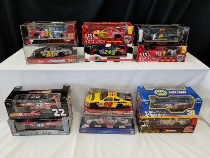 Qty (12) die-cast metal collectible race cars. Jeff Gordon, John Wayne, Ron Hornaday, and more. Please see pictures for complete lot details. See Lot 87 for more model cars.