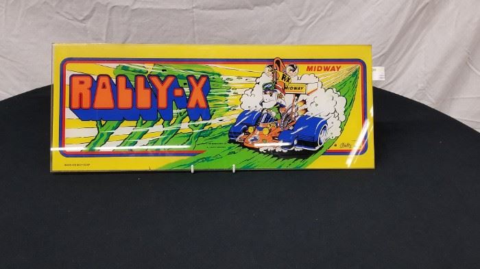 Vintage, Original Bally Midway "Rally X" glass arcade game marquee. Marquee measures approximately 23" W X 9" H. Stand not included. Please see all the additional pinball backglass and arcade game marquees that are offered throughout the auction.