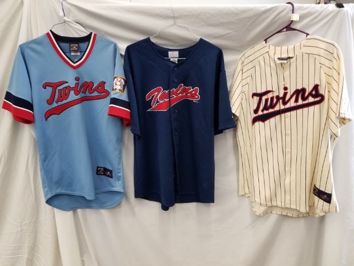 Qty (3) Throwback Minnesota Twins Jerseys. Navy Blue Jersey is size L. Powder Blue Jersey is M (tag still on). Cream button-up is size L. See other lots throughout auction for more baseball memorabilia.