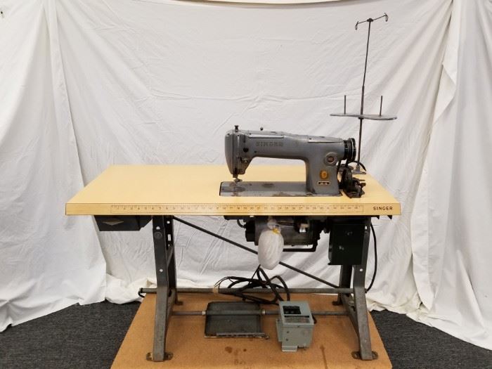 Singer 251-22 Industrial Sewing Machine with work table. Great for leather-working. We were told by client that it works, but we do not have 220V to test, so please inspect for yourself. Foot pedal needs to be attached. 220V, 3 phase motor. Approximate dimensions of table are 48" W X 21" D X 31" H. Please see lot 79 for assorted leathers. DOLLY NOT INCLUDED, so please bring help for removal, as this is heavy.