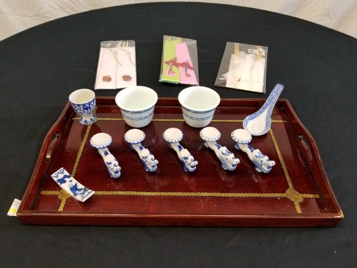 Japanese dining set. Serving tray, chopsticks, porcelain chopstick holders, melamineware teacups, Japanese sake shot glass and rice eye porcelain spoon. Tray measures 18" W X 11" L. Please see pictures for complete lot details.
