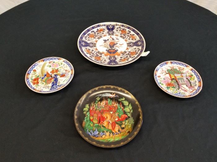 Decorative porcelain plates. 3 Asian themed plates and 1 Russian plate. Black Porcelain Russian plate is Brandex No. 60-V25-1.1 and has an 8" diameter. Large Asian plate is 10.5" Diameter. Smaller 2 Asian plates are 6.5" diameter. Please see pictures for complete lot details.