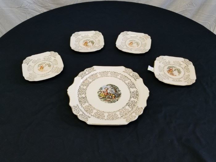 Lovely Royal LB 22K gold porcelain dessert plate set with Courting Victorian Couple. Large plate is approximately 12.5" diameter. 4 matching smaller plates are approximately 7.5" diameter.
