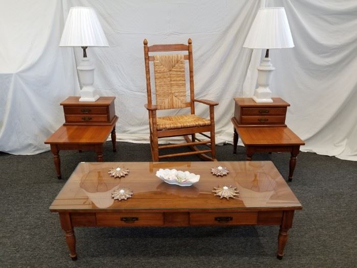 Beautiful wood rocking chair. Rush seat and back. Approximate dimensions are 26.5" W X 20.5" D X 20" seat height X 45.5" back height. Runners are approximately 34" long. This lot is for the rocking chair ONLY. End tables and lamps shown in pics are offered separately in lots 35, 35A, 49 and 50.
