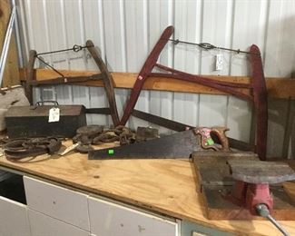 Antique buck saws. Bench vise.