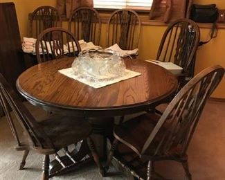 Oak Round table with leaf, includes 3 side chairs and 1 captain chair.