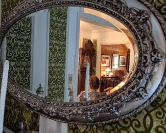 Very ornate silver mirror.