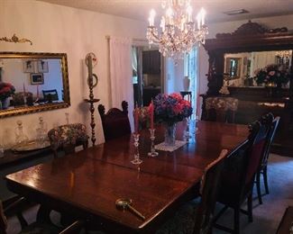 this magnificent dining room table and mirrored buffet was featured in the 1904 World's Fair. A European woodcarver was showing off his carving skills in this set--a show stopper!