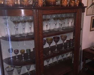 curved glass china cabinet with gorgeous early cut crystal and a 19th century German stein set