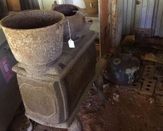 Oantque stove and Pot with plant pits and cabinet for sale in background