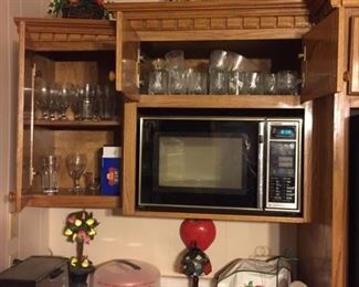 Small appliences, and kitchen cabinets filled with items