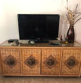 Stunning rattan entertainment console with brass elephant door pulls