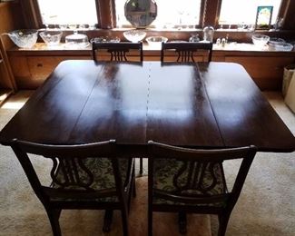 Antique drop leaf table with 4 chairs