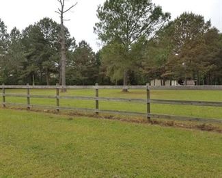 Property is fenced and gated along road side.