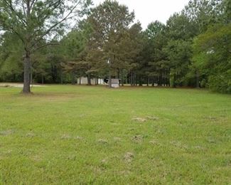 Property is partially cleared, leaving nice mature trees.