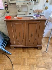 #132 Elna Sewing machine  $ 50.00 
#133 wood Cabinet/laminate top 32x15x30  $ 65.00