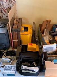 Old movie, movie case, reels, cameras, and misc.