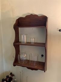 Antique shelf, beakers, glass shades.