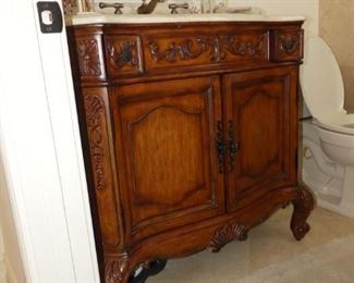 Bombe style bathroom vanity with stone top