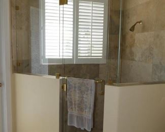 Frameless shower enclosure