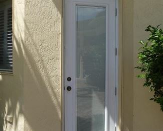 Cabana door with interior shade beneath crackled glass (exterior view)