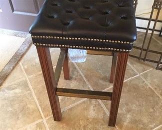 One of two nail head leather top stools