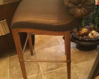 One of two upholstered roll back bar stools