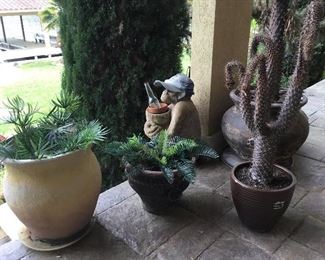 Plants, planters and lovely monkey in hat holding a bottle