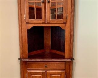 Canadel solid wood corner cabinet with light feature