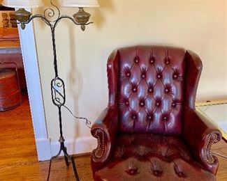 Tufted red leather chair with hobnail detail and vintage standing lamp
