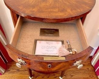 Theodore Alexander replica of George III mahogany demilune table with brass feet.  I of 2.