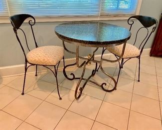 Round marble topped cafe table with metal base and two metal cafe chairs