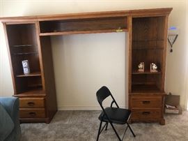 Lighted entertainment center with glass shelves and storage cabinets